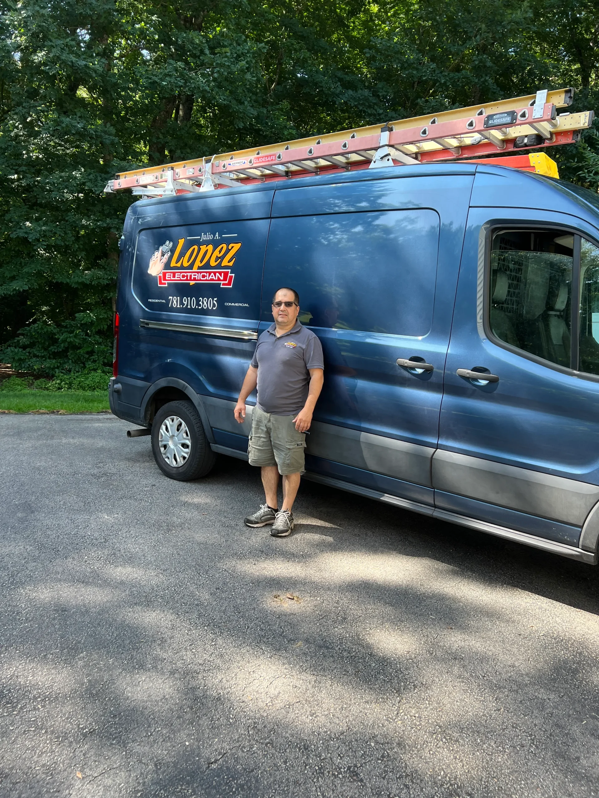 Portrait of Julio Lopez Electrician with his working vehicle.