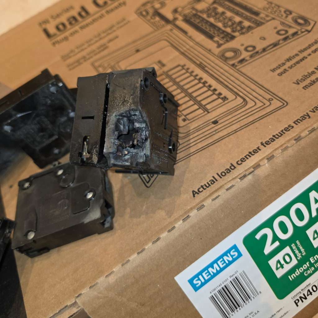 Burned circuit breaker removed from a damaged electrical panel