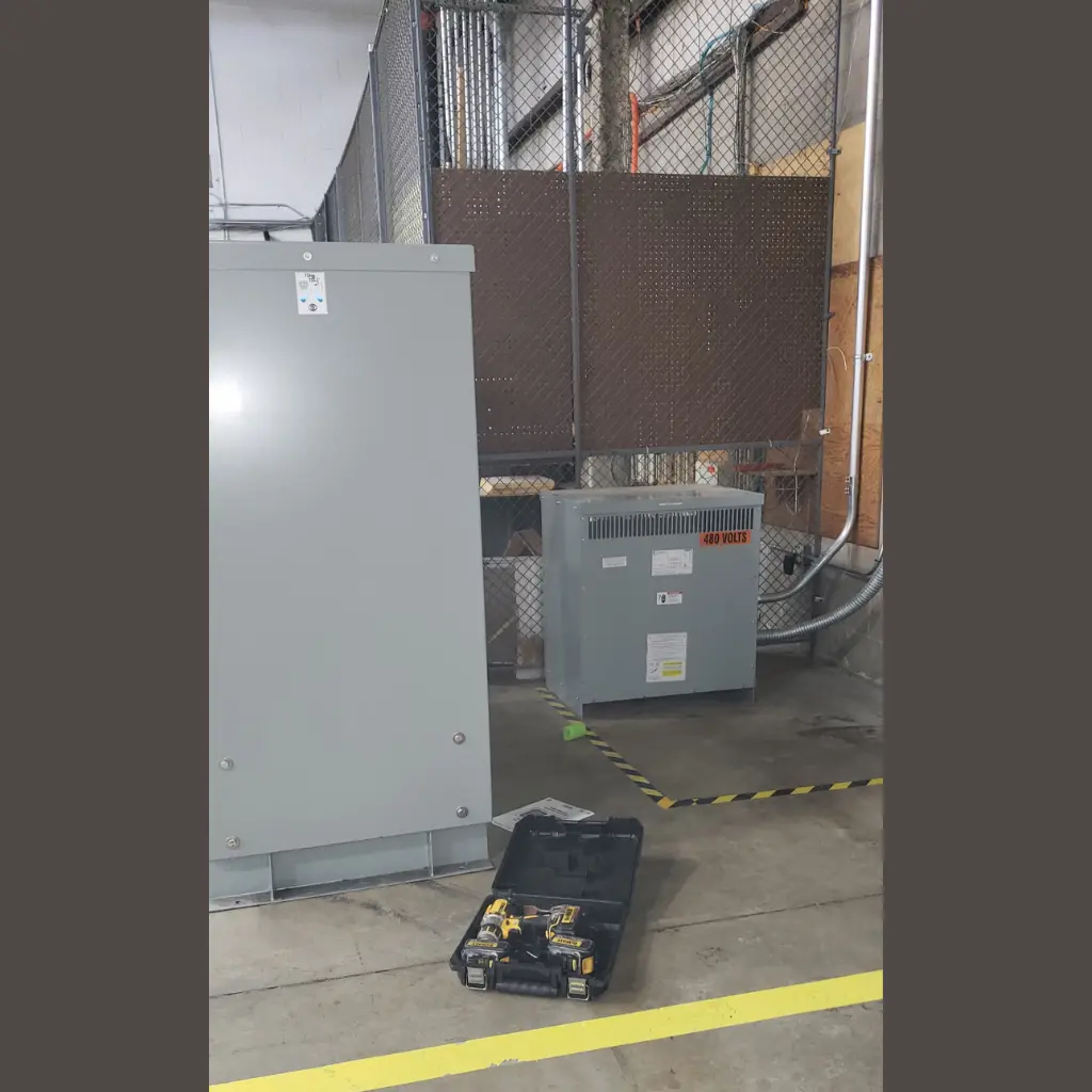 Commercial electrical cabinet and 480-volt transformer installed inside an industrial facility