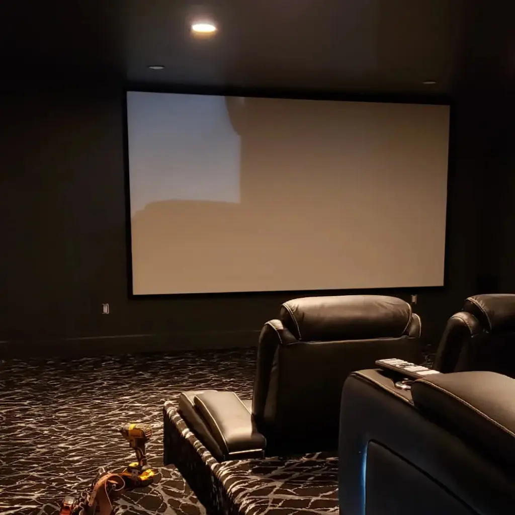 Home theater with recessed ceiling lights and illuminated seating steps during electrical work