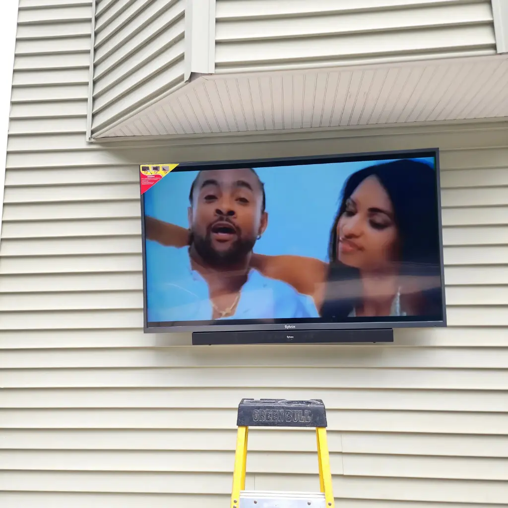 Outdoor TV and soundbar installation on a residential home
