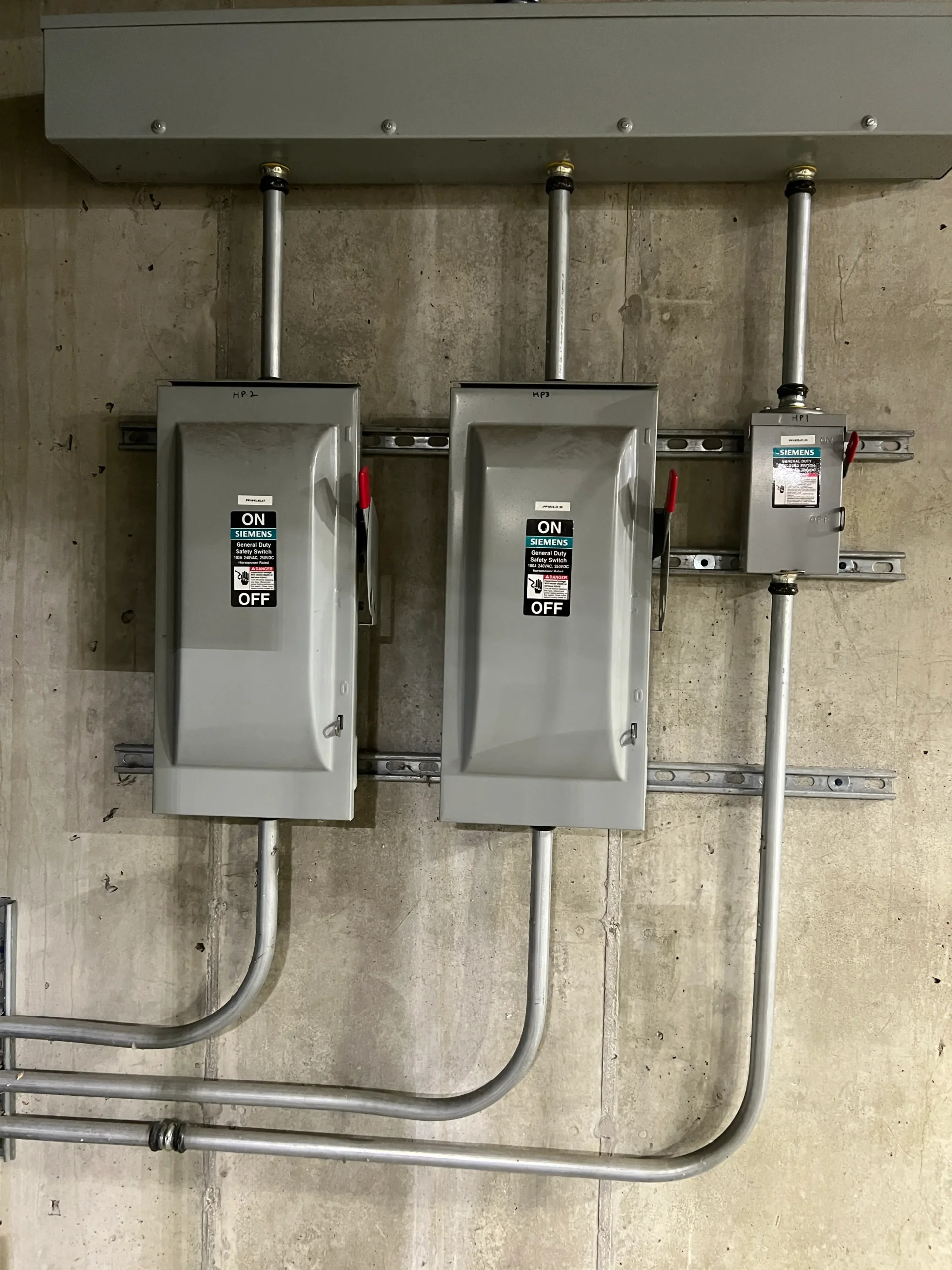 Electrical disconnect switches and conduit installed for an EV charging station
